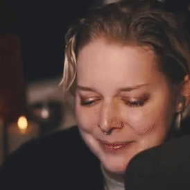 A Close Up Of A Woman 'S Face With A Smiley Face On It . GIF