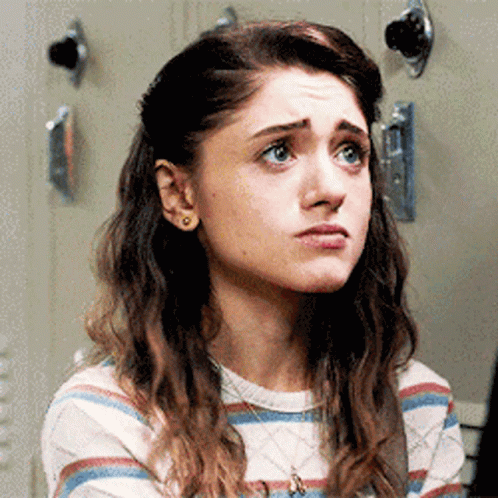A Close Up Of A Woman 'S Face With A Striped Shirt And A Necklace . GIF