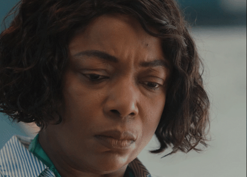 A Close Up Of A Woman 'S Face With A Striped Shirt GIF