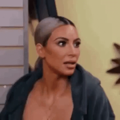 A Close Up Of A Woman 'S Face With A Surprised Expression . GIF