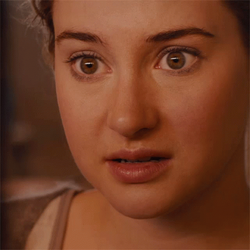 A Close Up Of A Woman 'S Face With A Surprised Expression GIF