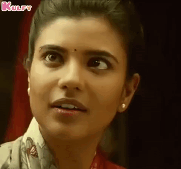 A Close Up Of A Woman 'S Face With A Surprised Expression On Her Face . GIF