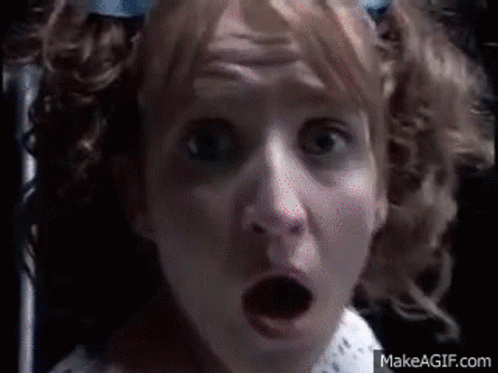 A Close Up Of A Woman 'S Face With A Surprised Look On Her Face .. GIF