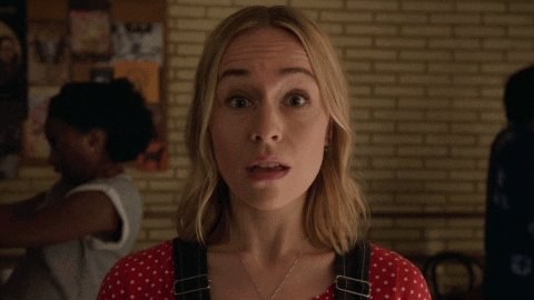 a close up of a woman 's face with a surprised look on her face