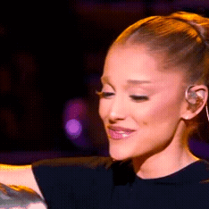 A Close Up Of A Woman 'S Face With A Tattoo On Her Arm . GIF