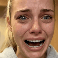 A Close Up Of A Woman 'S Face With A Tear Coming Out Of Her Eye GIF