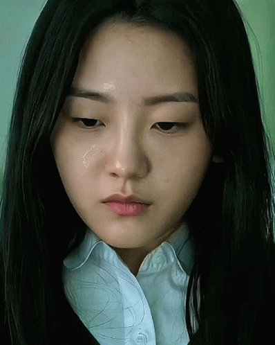 A Close Up Of A Woman 'S Face With A Tear Coming Out Of Her Eye GIF