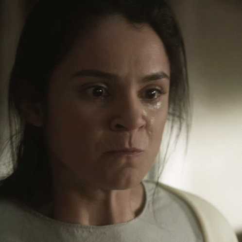A Close Up Of A Woman 'S Face With A Tear Running Down Her Cheek GIF