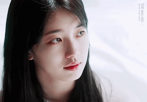 A Close Up Of A Woman 'S Face With A Tear Running Down Her Cheek GIF