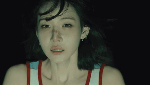 A Close Up Of A Woman 'S Face With A Tear Running Down Her Cheek GIF