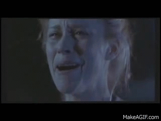 A Close Up Of A Woman 'S Face With A Tear Running Down Her Cheek . GIF