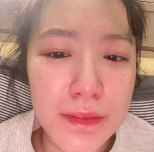 A Close Up Of A Woman 'S Face With A Tear Running Down Her Eye GIF