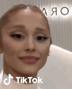 A Close Up Of A Woman 'S Face With A Tik Tok Sticker On It . GIF