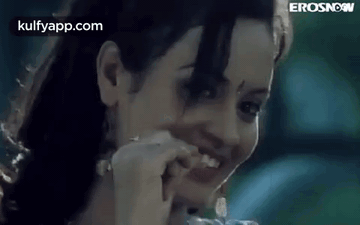 A Close Up Of A Woman 'S Face With A Toothpick In Her Mouth . GIF
