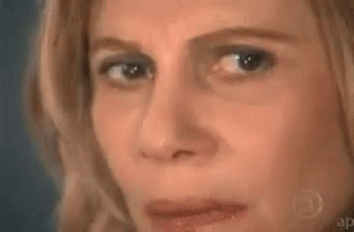 A Close Up Of A Woman 'S Face With A Triangle And A Mathematical Equation On It . GIF