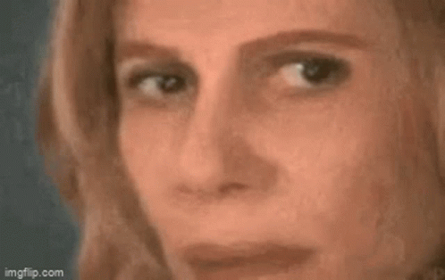 A Close Up Of A Woman 'S Face With A Triangle On Her Forehead And A Mathematical Equation . GIF