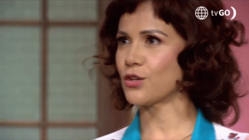 A Close Up Of A Woman 'S Face With A Tv Go Logo Behind Her GIF