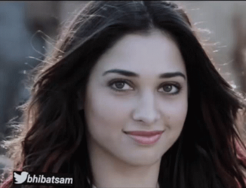 A Close Up Of A Woman 'S Face With A Twitter Logo On The Bottom Right GIF