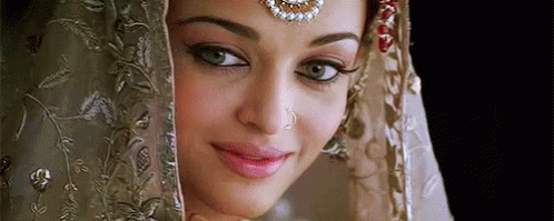 A Close Up Of A Woman 'S Face With A Veil Covering Her Face . GIF