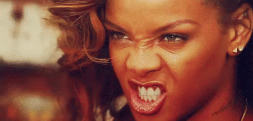 A Close Up Of A Woman 'S Face With A Very Angry Expression . GIF