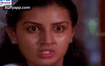 A Close Up Of A Woman 'S Face With A Very Angry Look On Her Face . GIF