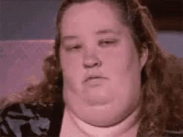 A Close Up Of A Woman 'S Face With A Very Large Neck . GIF