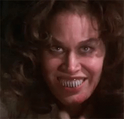 a close up of a woman 's face with a very large smile .