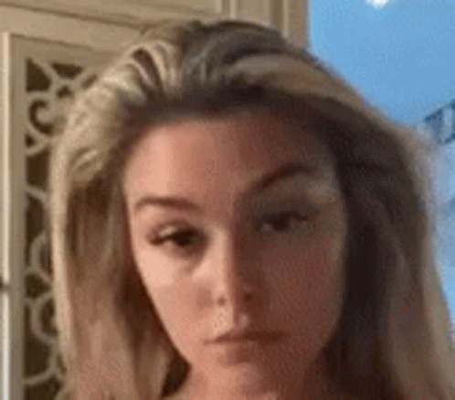 A Close Up Of A Woman 'S Face With A Very Serious Look On Her Face . GIF