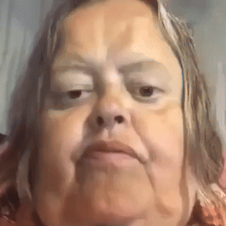 A Close Up Of A Woman 'S Face With A Very Serious Look On Her Face . GIF