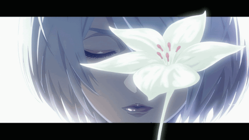 A Close Up Of A Woman 'S Face With A White Flower In Front Of Her Eyes GIF