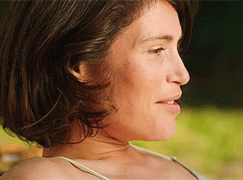 A Close Up Of A Woman 'S Face With A White Shirt On GIF