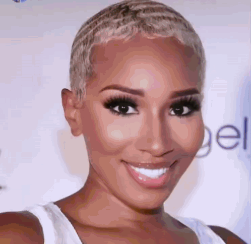 A Close Up Of A Woman 'S Face With A White Tank Top On GIF