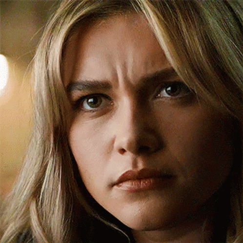 A Close Up Of A Woman 'S Face With A Wrinkle On Her Forehead . GIF