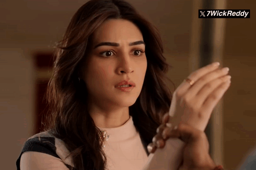 A Close Up Of A Woman 'S Face With A X7wick Reddy Logo In The Background GIF