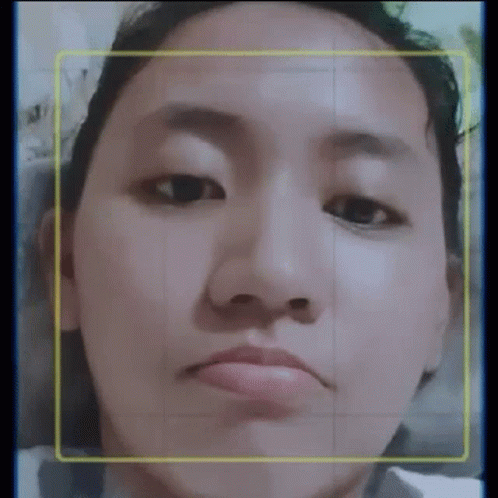 a close up of a woman 's face with a yellow border around her face .