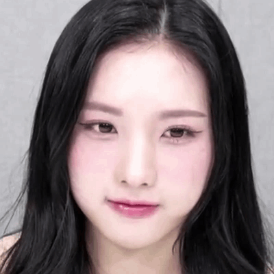 A Close Up Of A Woman 'S Face With Black Hair And Pink Lips GIF