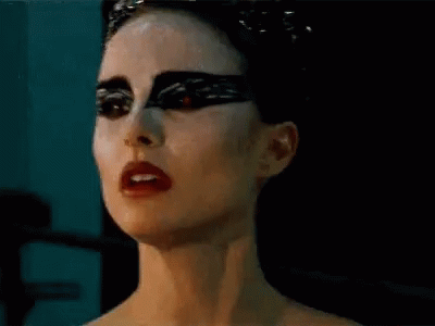 A Close Up Of A Woman 'S Face With Black Makeup And Red Lipstick . GIF
