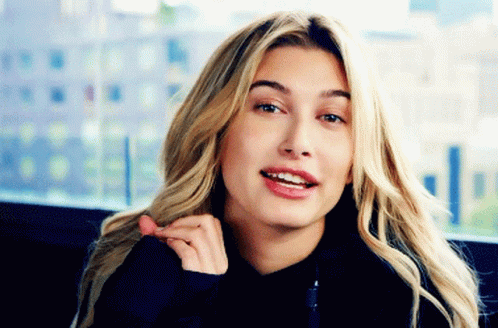 A Close Up Of A Woman 'S Face With Blonde Hair GIF