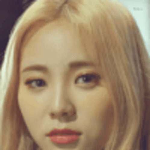 A Close Up Of A Woman 'S Face With Blonde Hair . GIF