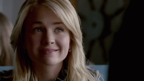 Close Up Of Woman's Face With Blonde Hair And Green Eyes GIF