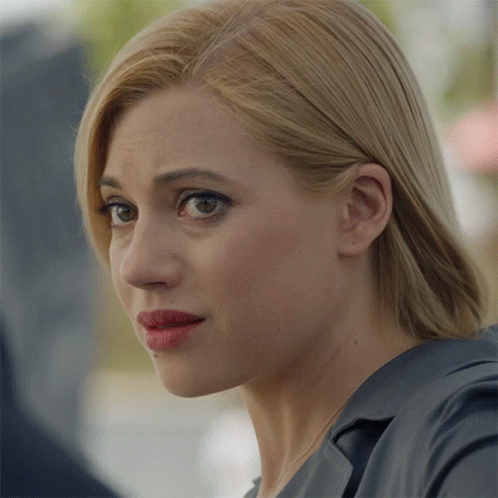 A Close Up Of A Woman 'S Face With Blonde Hair And Red Lipstick GIF