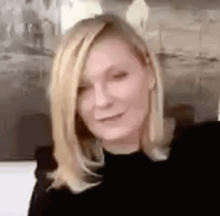 A Close Up Of A Woman 'S Face With Blonde Hair . GIF