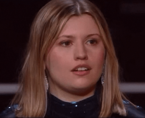 A Close Up Of A Woman 'S Face With Blonde Hair GIF