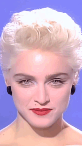 A Close Up Of A Woman 'S Face With Blonde Hair GIF