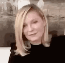 A Close Up Of A Woman 'S Face With Blonde Hair . GIF