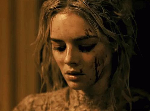 A Close Up Of A Woman 'S Face With Blood On Her Face GIF