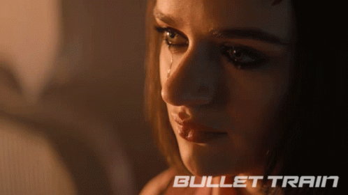 A Close Up Of A Woman 'S Face With Bullet Train Written On The Bottom Right GIF