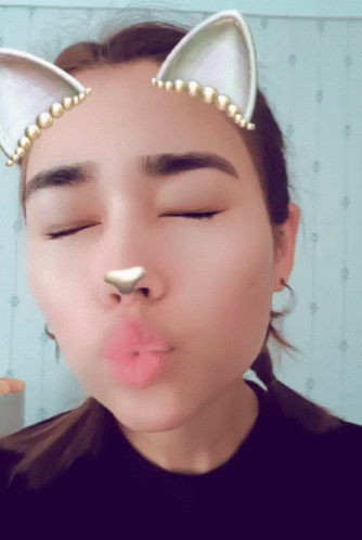 A Close Up Of A Woman 'S Face With Cat Ears On GIF