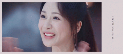 A Close Up Of A Woman 'S Face With Chinese Writing GIF