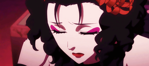 A Close Up Of A Woman 'S Face With Closed Eyes And A Flower In Her Hair GIF